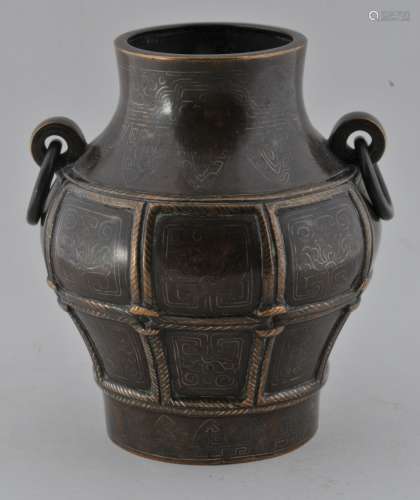 Bronze vase. China. 18th century. Archaic bronze Hu form with jump rings and rope designs. Surface inlaid with scrolling in silver. Signed Shih So on the base. 4-1/2