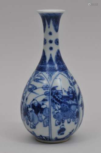 Porcelain vase. China. 20th century. Pear form with a flaring neck. Underglaze blue decoration of lotus petal reserves of children playing. Artemesia leaf mark. 7