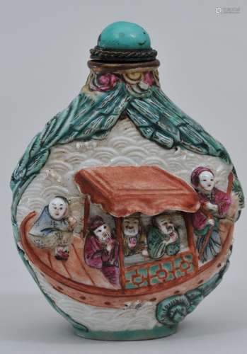 Snuff bottle. China. 19th century. Carved porcelain with figures on a pleasure boat. Polychromed surface. 2-1/2