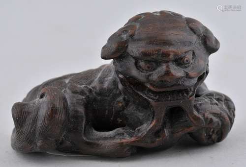 Wooden Netsuke. Japan. 19th century. Study of a shishi. Signed. 2