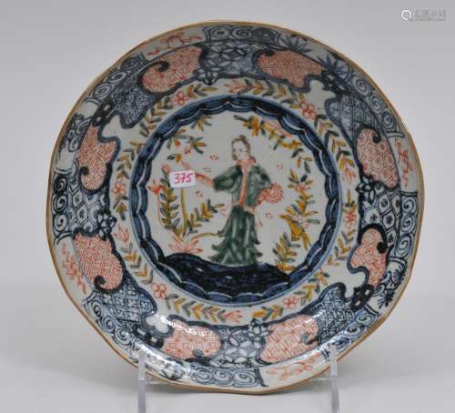 Porcelain plate. China. 20th  century. Ming style decoration of a European woman with underglaze blue brocade patterns. 7-1/4