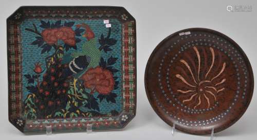 Lot of two metal works. To include: A 19th century Japanese Cloisonné square tray decorated with a peacock and peonies together with a Taisho (1912-1926) bronze dish inlaid with silver and other alloys.  From the Estate of Jeanette Curuby.