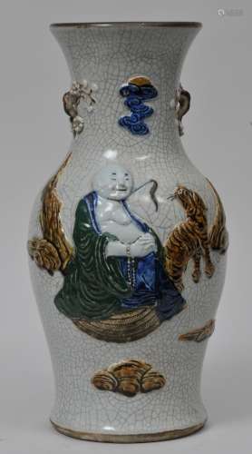 Porcelain vase. China. 19th century. Baluster form. Moulded prunus handles. Relief decoration of Luohan and a tiger in green, blue and brown on a crackled white ground. 18