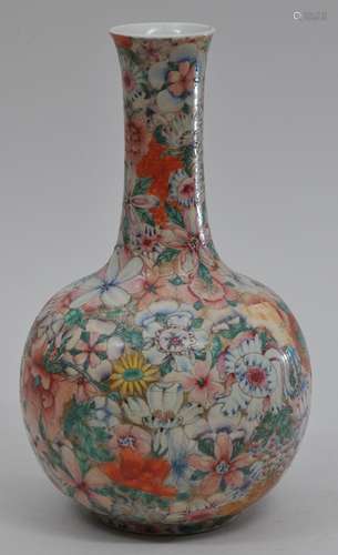 Porcelain vase. China. Early 20th century. Famille rose millie fleur decoration on a gold ground. Ch'ien Lung mark in red. 9