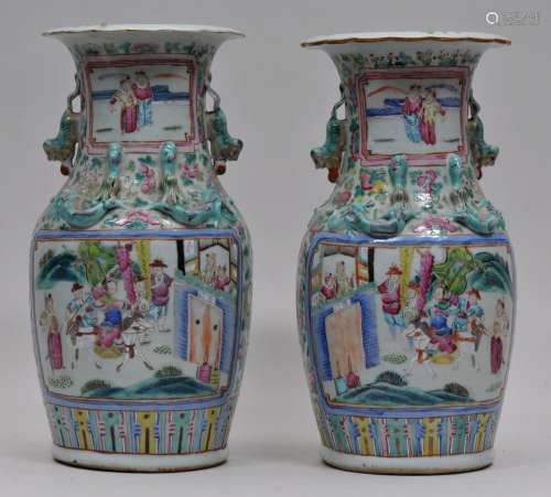 Pair of porcelain vases. China. 19th century. Foo Dog handles, dragons at the shoulder. Famille Rose decoration of historical scenes on a floral ground. 13-1/2