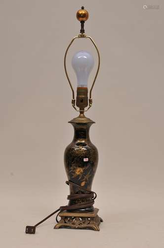 Porcelain vase. China. 19th century. Baluster form. Mirror black with gilt decoration of flowers on a thunder meander ground. Drilled and mounted as a lamp. 9-3/4