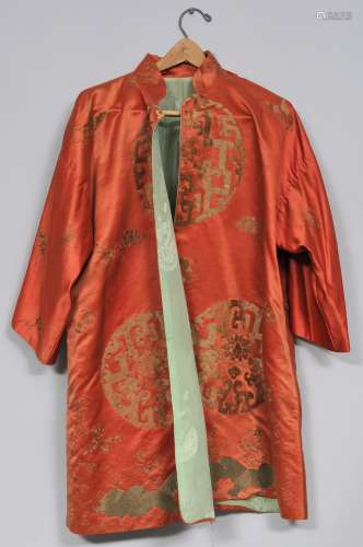 Silk robe. China. 19th century. Gold embroidery of archaic scroll roundels, butterflies and flowers on an orange ground. Loose threads and stains.