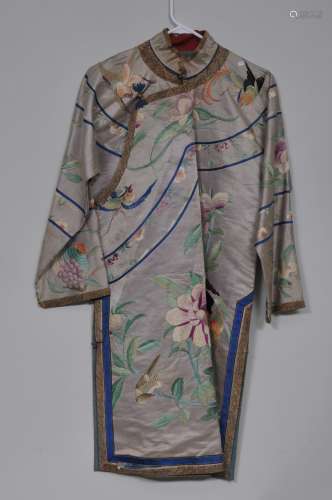 Silk robe. China. Early 20th century. Embroidery of birds and flowers on a pale lavender ground. Some stains.