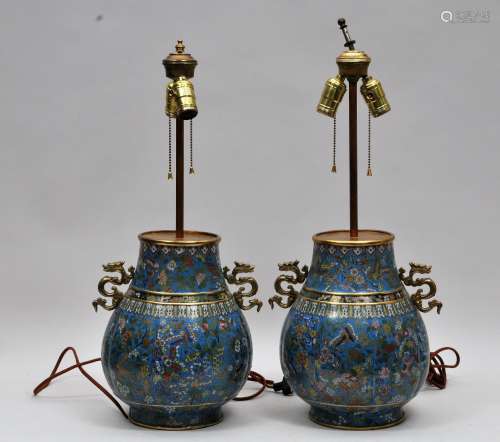 Pair of Cloisonné vases. China. 18th/19th century. Pear shaped with lobated bodies and dragon handles. Decoration of flowers and butterflies on a turquoise ground. Drilled and mounted as a lamp. 12