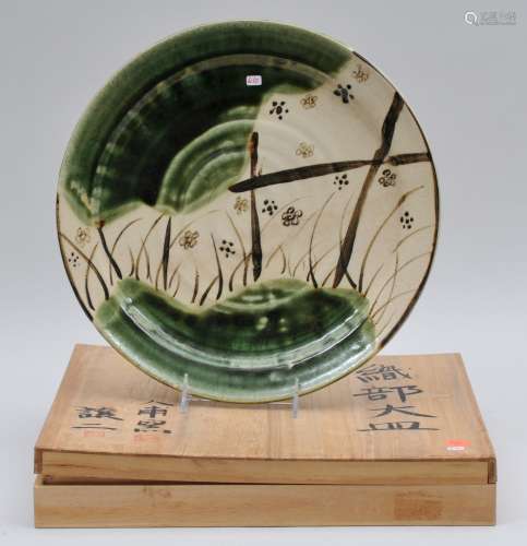 Stoneware dish. Japan. 20th century. Oribe ware. Green and black decoration. 12-1/4