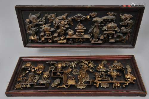 Pair of wood carvings. China. Early 20th century. Design of The Hundred Antiques. Surface lacquered in red and gold. Framed. 31-1/2