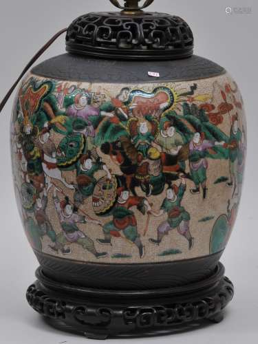 Porcelain jar. China. Early 20th century. Oatmeal glaze with a Famille Rose historical scene. Borders of carved dark  brown. Drilled and mounted as a lamp. 11