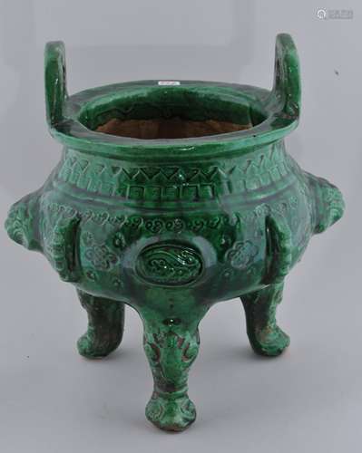 Pottery censer. China. 19th century. Archaic Ting Tripod form. Impressed and moulded decoration beneath a bright green glaze. 8