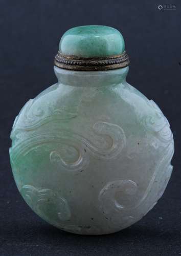 Jadeite Snuff bottle. Late 19th century. China. Flattened rounded form. Stone of a pale lavender with apple green. Surface carved with swirling clouds. 2