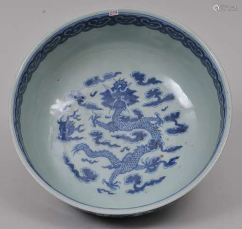 Porcelain bowl. China. 19th century. Underglaze blue decoration of dragons, pearls and clouds. Ju-i border. 11-1/4