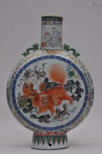 Porcelain vase. China. 19th century. Moon flask form. Dragon handles. Decoration of foo dogs in iron red. Borders of birds and flowers in Famille Rose enamels. 19