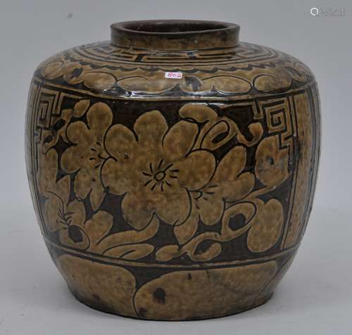 Stoneware jar. South China. 19th century. Carving of flowers. Yellow brown on a brown glaze. 9