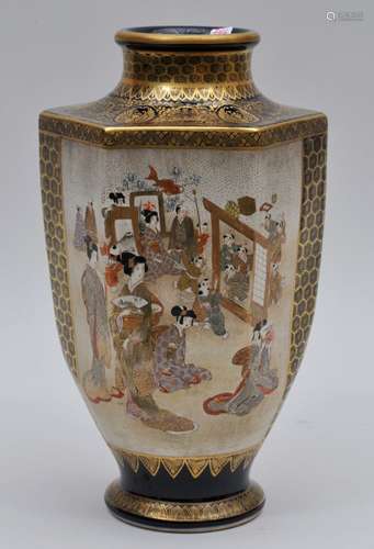 Pottery vase. Japan. Meiji period. (1868-1912). Satsuma ware. Reserves of women and children playing. Gilt brocade borders on a cobalt blue ground. Drilled for a lamp. 10-1/4