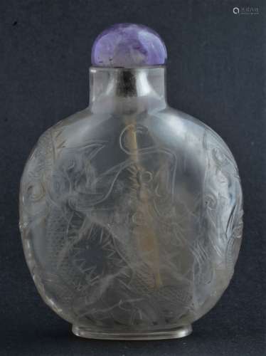 Rock Crystal Snuff bottle. China. 19th century. Surface carved with dragons. Amethyst stopper. 3-1/2