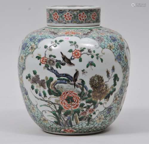 Porcelain covered jar. China. 19th century. Famille Verte decoration of floral reserves on a flower strewn cracked ice ground. 11