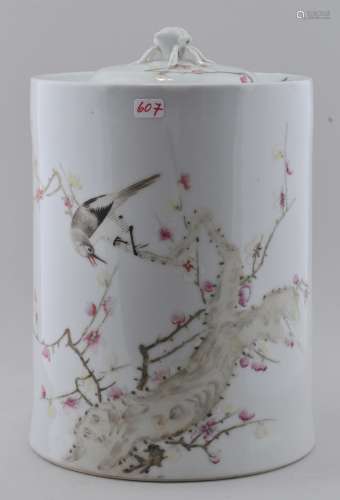 Covered jar. China. Republic Period. Circa 1930. Famille Rose decoration of a bird in a flowering tree. Cylindrical form. Peach finial.  8