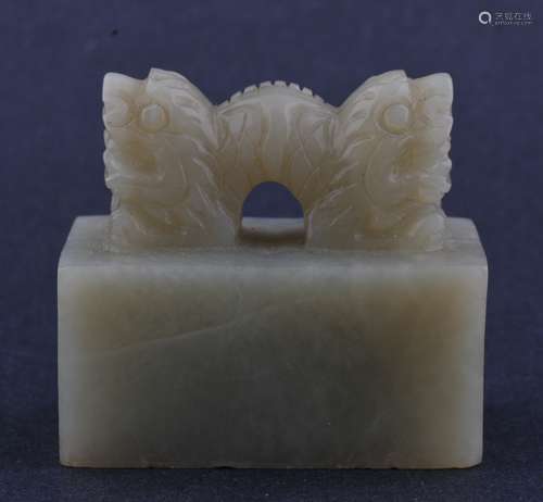 Soapstone seal. China. Early 20th century. Grey-green stone. Rectangular form with a double dragon finial. Seal intact. 2