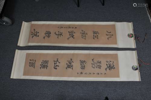 Pair of hanging scrolls. China. 20th century. Calligraphy on paper. 53-1/2