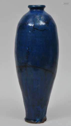 Stoneware vase. China. Yuan period (1279-1368). Tzu Chou type. Deep blue glaze with underglaze decoration of flowering magnolia. (Repair to the mouth and body). 15-1/2