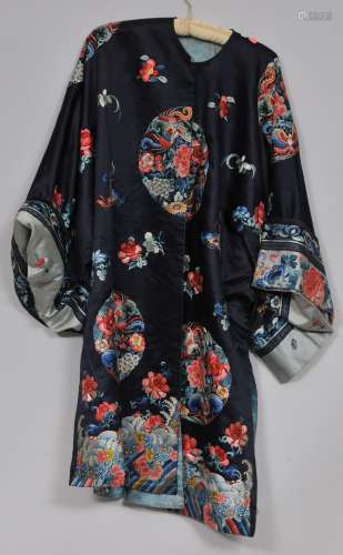 Silk robe. China. 19th century. Roundels of flowers and butterflies on a dark blue ground with a Li Shui hem.