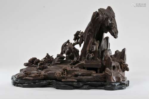 Agarwood carving. China. 19th century. Very large landscape with a scene of an archery contest. Fitted stand. 17