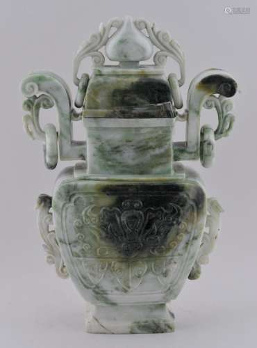 Jade covered jar. China. 20th century. Green and white stone. Tao Tieh masks with foliated handles. 9