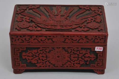 Lacquer box. China. 19th century. Rectangular shape. Two color cinnabar lacquer. Carving of a basket of auspicious items. Stylized floral borders 6-1/4