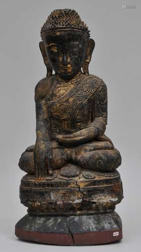 Carved wooden Buddha. Burma. 19th century. Seated figure in the earth witnessing Mudra. Surface lacquered black, red and gold. 18-3/4