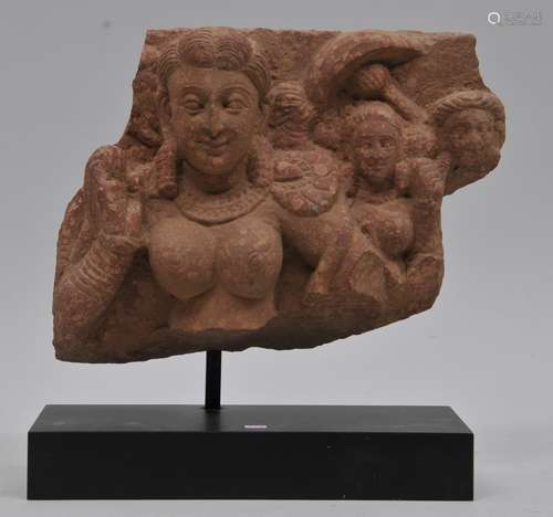 Stone carving. North West India. Mathura period. 1rst C AD. Red sandstone carved with a woman and attendants. 11