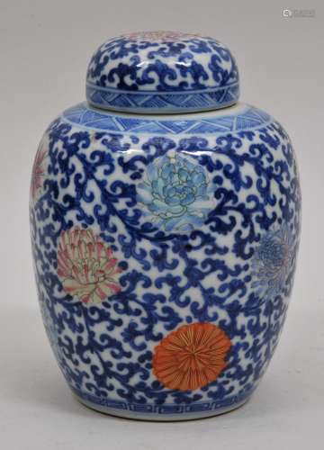 Porcelain covered jar. China. Early 20th century. Underglaze blue decoration of vines with Famille Rose enamels of flowers, 6-1/2