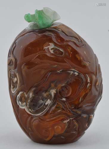 Agate pebble Snuff Bottle. China. 19th century. Surface carved with Ling Chih. Jadeite stopper. 2-1/2