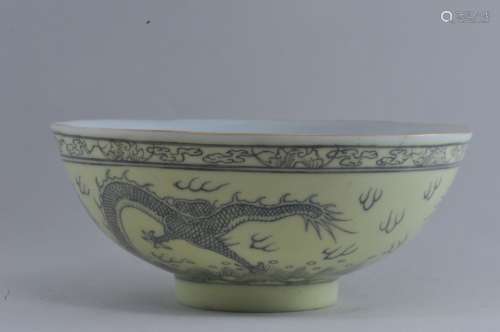 Porcelain bowl. China. 19th century. Pale yellow glaze with underglaze dragons and pearls. Four character honorific mark on the base. 4-3/4