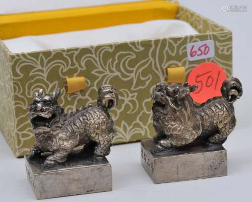 Pair of silver seals. China. 20th century. Foo dog finials. Dated 2nd year of Kuang Hsu. 1