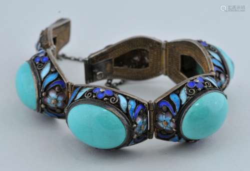 Turquoise and silver bracelet. China. 20th century.  Turquoise cabochons set in filigreed enameled silver.