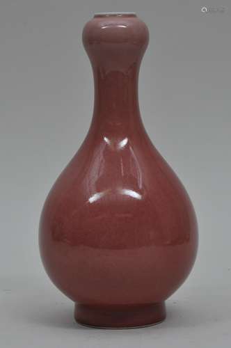 Porcelain vase. China. 19th century. Garlic mouth form. Peach bloom glaze. 8-1/2