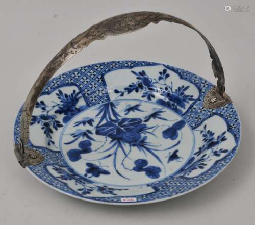 Porcelain plate. China. K'ang Hsi period (1662-1722). Underglaze blue floral decoration. Continental engraved silver bail handle. 8-3/4