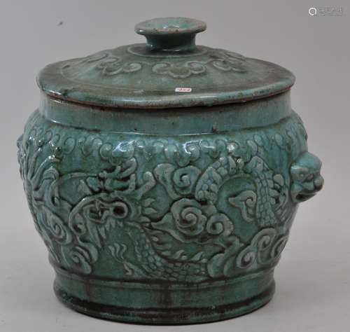 Stoneware covered jar. China. 19th century. Moulded decoration of phoenixes and peony flowers with ju-i borders. Turquoise glaze. 10