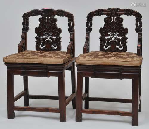 Pair of Rosewood chairs. China. 19th century. Surfaces carved with intertwined Ju-i sceptres. 36