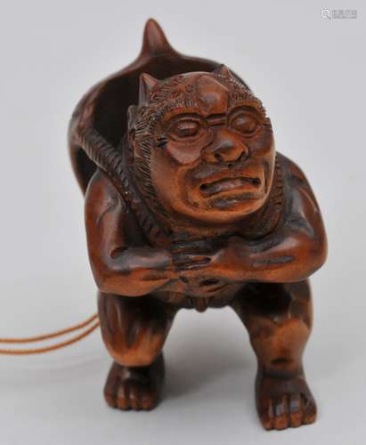 Wooden Netsuke. Japan. 20th century. Demon with a demon mask. 2