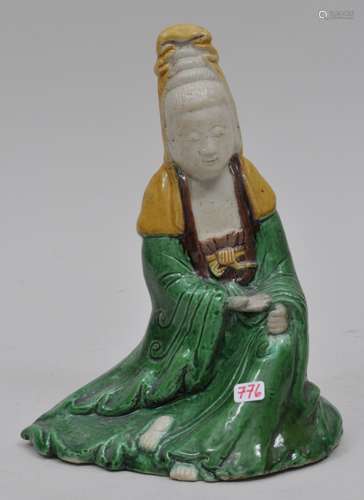 Biscuit figure of Kuan Yin. China. 18th century. San Tsai glaze of green, yellow and aubergine. 7