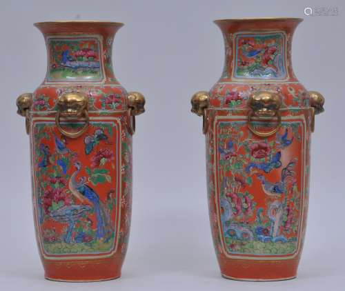 Pair of porcelain vases. China. 19th century. Four gilded foo dog faux jump rings. Famille Rose decoration of birds, flowers and butterflies on an orange ground. 12-1/4