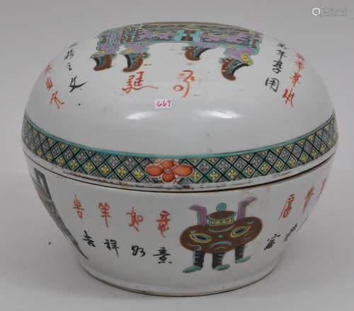 Porcelain box and cover. China. 19th century. Round form. Famille Rose decoration of archaic cauldrons and calligraphy. 11