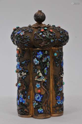 Silver tea caddy. China. Early 20th century. Lobated cylindrical form. Giled filigree surface decorated with birds and flowers with enamel work and inset cabochons of coral and turquoise. 7