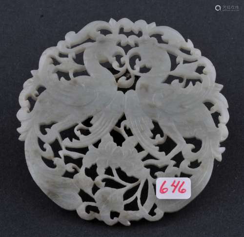 Jade pendant. China. 19th century. Stone of a grey green colour. Carved and pierced with phoenixes and floral scrolling. 3