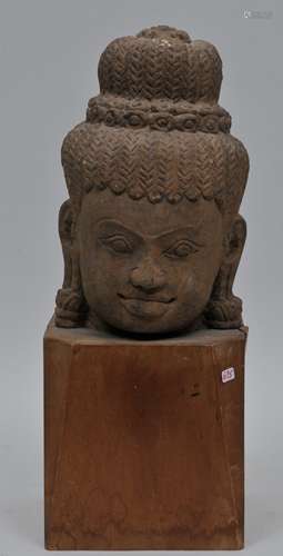 Carved red sandstone head. Khmer. 13th century. Wooden base. 8-1/4